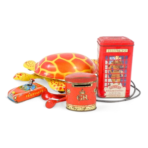 520 - A vintage Mobo tinplate tortoise - decorated in yellow and red, 29cm wide, together with a tinplate ... 