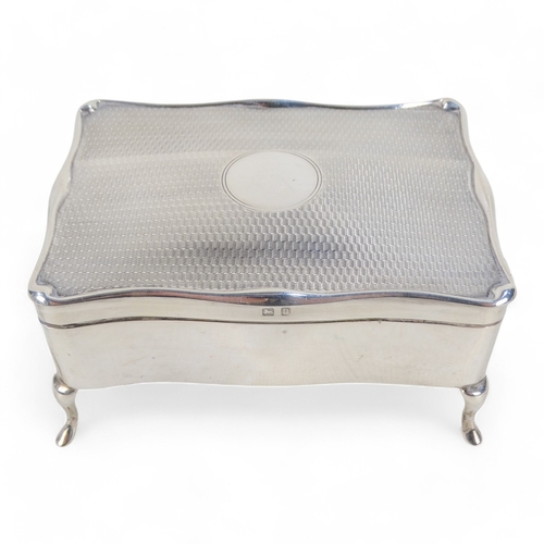 526 - A silver jewellery casket - Birmingham 1912, rectangular with engine turned hinged lid and velvet fi... 