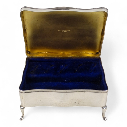 526 - A silver jewellery casket - Birmingham 1912, rectangular with engine turned hinged lid and velvet fi... 