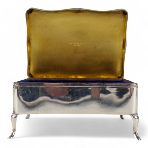 526 - A silver jewellery casket - Birmingham 1912, rectangular with engine turned hinged lid and velvet fi... 