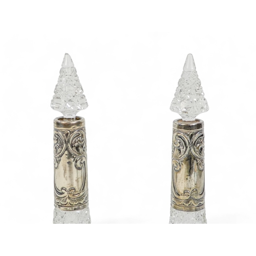 536 - A pair of clear cut glass and silver mounted perfume bottles - Birmingham 1903, of trumpet form with... 