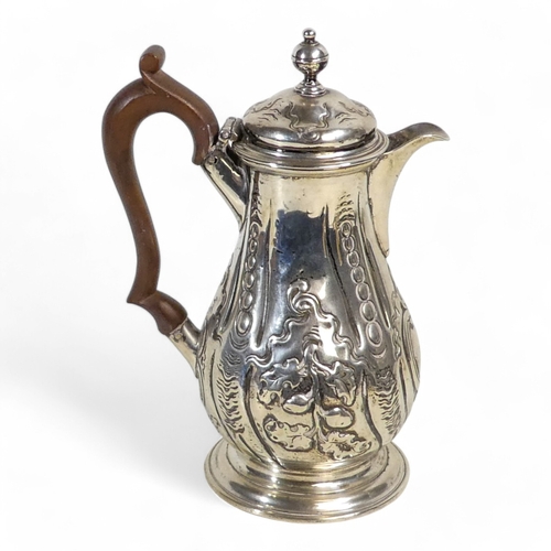 538 - A silver hot water jug - London 1772, of baluster form with later repousse decoration, 360g.