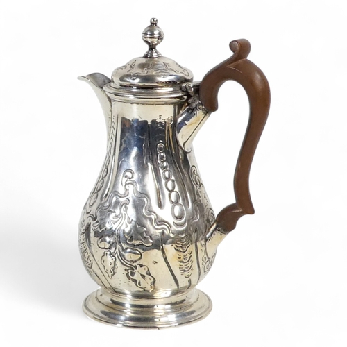 538 - A silver hot water jug - London 1772, of baluster form with later repousse decoration, 360g.