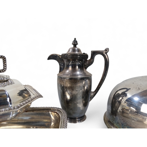 581 - A small quantity of silver plated ware - including an oval domed cloche, a hot water jug, an entree ... 