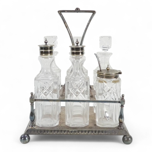 586 - An early 20th century silver plated cruet set - with clear glass square cut bottles within a rectang... 