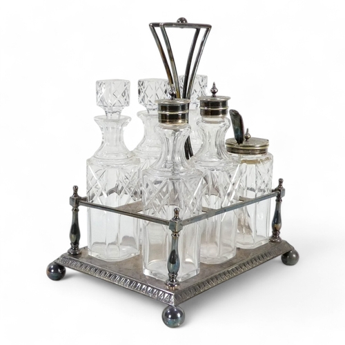 586 - An early 20th century silver plated cruet set - with clear glass square cut bottles within a rectang... 