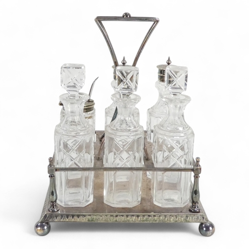 586 - An early 20th century silver plated cruet set - with clear glass square cut bottles within a rectang... 