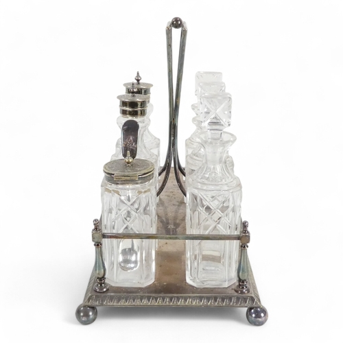 586 - An early 20th century silver plated cruet set - with clear glass square cut bottles within a rectang... 