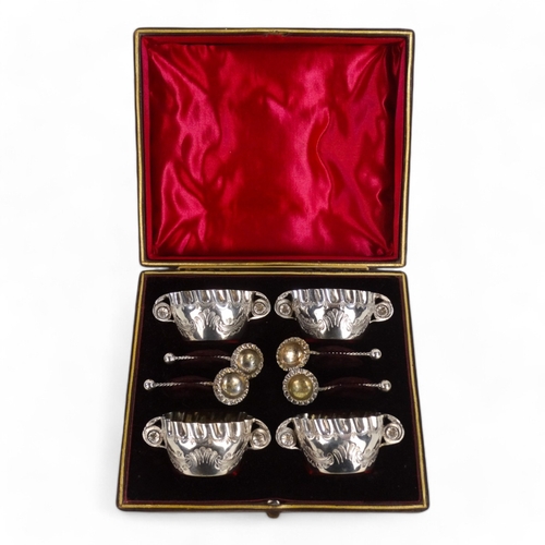 589 - A boxed set of four silver plated salts - with foliate engraving and crimped edges.