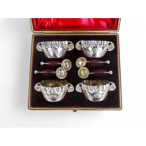 589 - A boxed set of four silver plated salts - with foliate engraving and crimped edges.