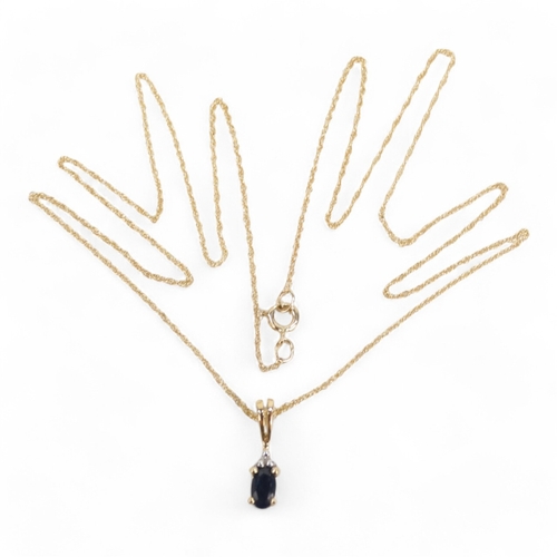 613 - A 9ct gold suite of jewellery set with sapphires - comprising a pendant on a fine link chain, a brac... 