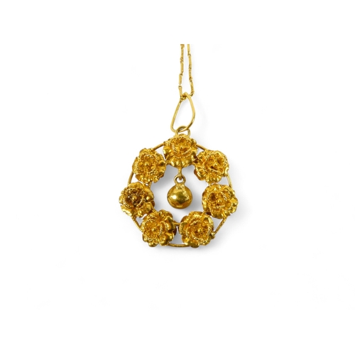 617 - A gilt wreath pendant and chain - probably high carat gold, formed from seven rose buds, on a fine l... 