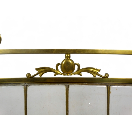 62 - An early 20th century Art Nouveau style brass and glass fire screen - the brass frame fitted with si... 