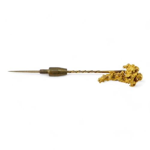 621 - A natural form gold nugget - fashioned into a stick pin, 8.8g.