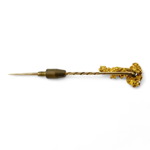 621 - A natural form gold nugget - fashioned into a stick pin, 8.8g.