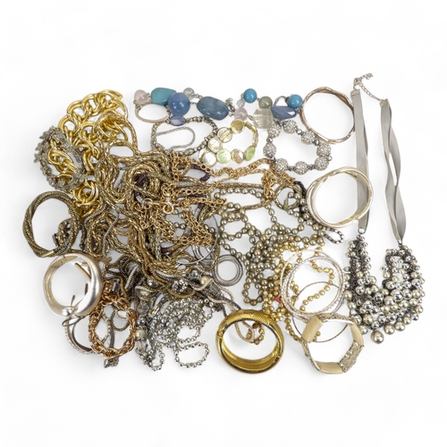 628 - A quantity of costume jewellery - including necklaces, bangles and brooches.