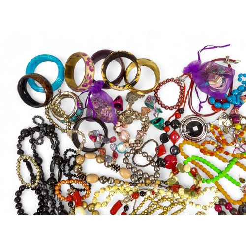 629 - A quantity of costume jewellery - including necklaces, bangles and brooches.