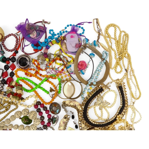 629 - A quantity of costume jewellery - including necklaces, bangles and brooches.