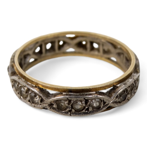 632 - An eternity band - the open setting with white stones set in clusters of three, size N, 2.9g.