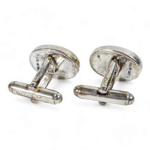 639 - A pair of sterling silver cufflinks - the oval buttons engraved with the letter 'H', weight 15.5g, b... 