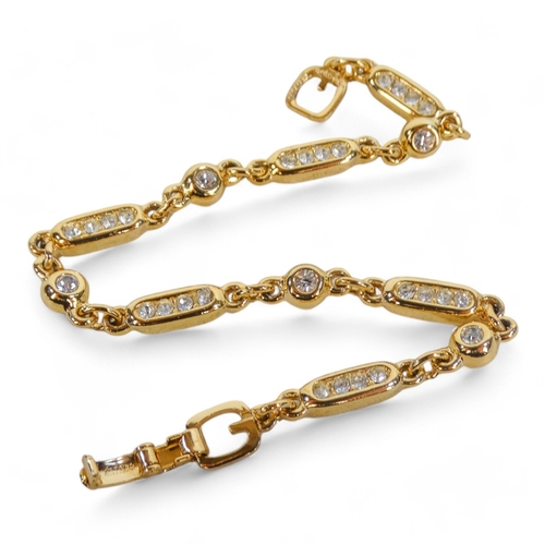 646 - A Grosse for Dior yellow metal bracelet - set white stones, with pouch and box.