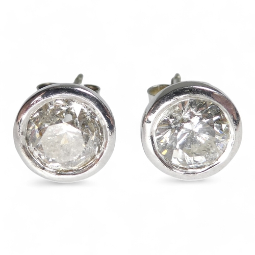 653 - A pair of solitaire diamond ear studs - stones, total carat weight approx 2ct, set in 9ct white gold... 