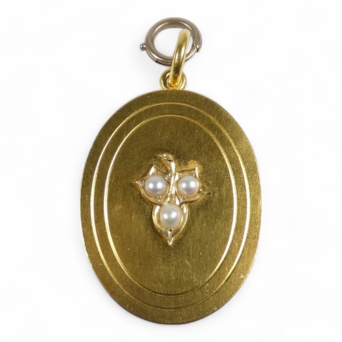 658 - A yellow metal and pearl set oval locket - foliate set with pearls, probably high carat gold, 21.6g.