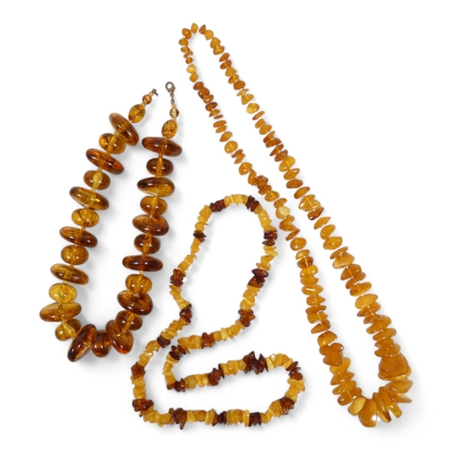 663 - A string of amber beads - of interspersed beads and disks, 44cm long, together with two further stri... 