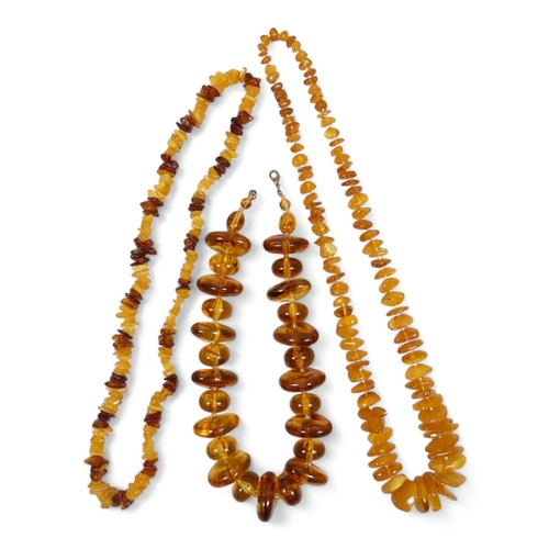 663 - A string of amber beads - of interspersed beads and disks, 44cm long, together with two further stri... 