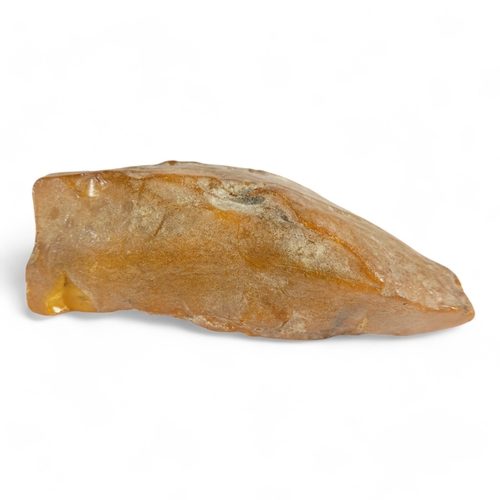 666 - A large piece of un-worked amber - 11 x 6cm, 137g.