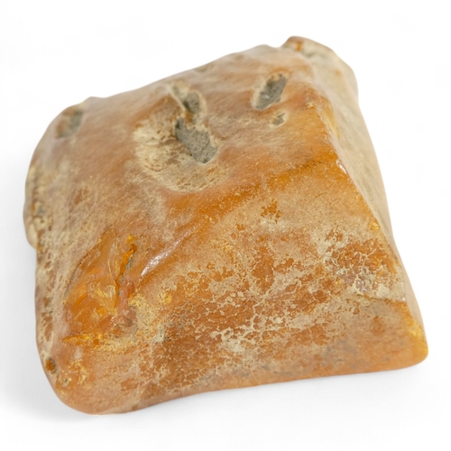 666 - A large piece of un-worked amber - 11 x 6cm, 137g.