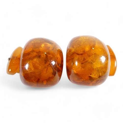 667 - A pair of amber cufflinks - of domed rectangular form linked by chain to smaller torpedoes, 14g.