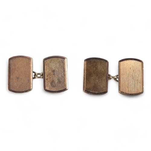 677 - A pair of 9ct gold cuff links - of rounded rectangular form with engine turning, together with a sma... 