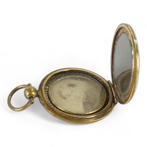 678 - A yellow metal locket - probably 9ct gold, circular with foliate engraving, 10.6g all in.