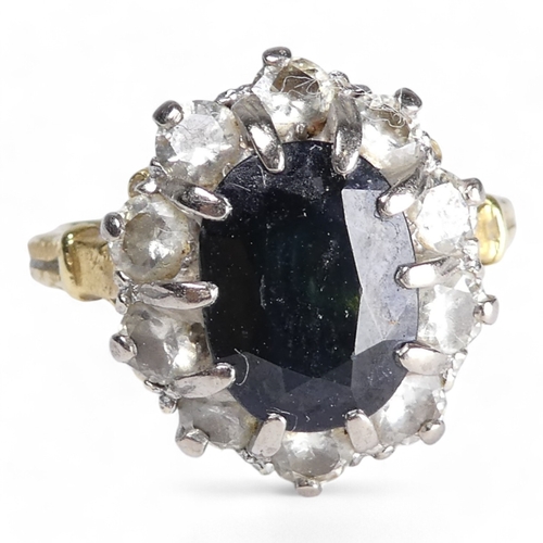 680 - A 9ct sapphire and diamond ring - the claw set oval central stone within a band of diamonds, size R,... 