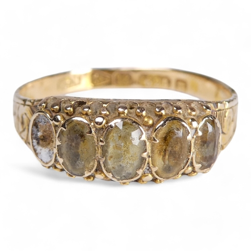 681 - A 15ct five stone ring - set with citrine (one vacant setting) with a foliate engraved band, size Q,... 