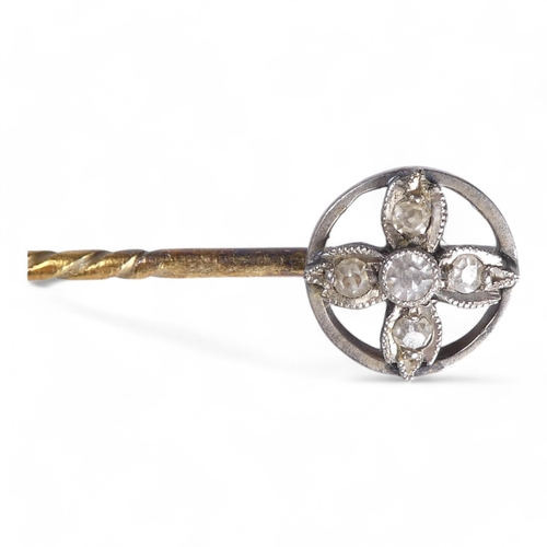 685 - A gold stick pin - as a natural nugget, 4.9g, together with two further stick pins, one floral set w... 