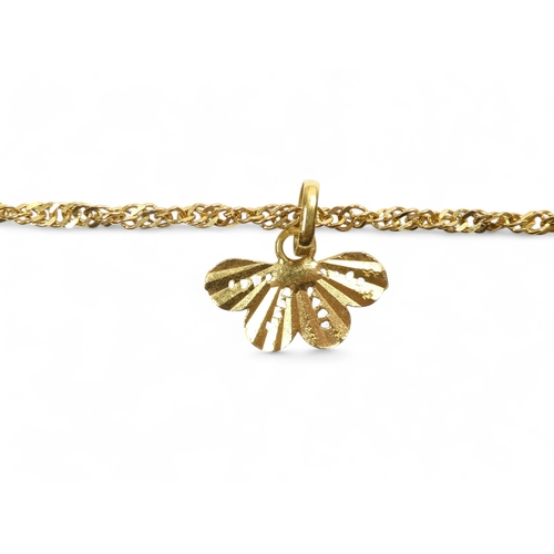 686 - A yellow metal bracelet - of pierced foliate form linked by chain, stamped 21ct, 37.8g.