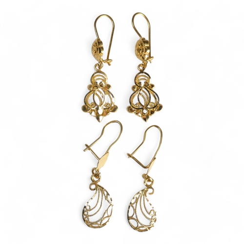 689 - A pair of yellow metal filigree earrings - of foliate form, stamped 21ct, together with another simi... 