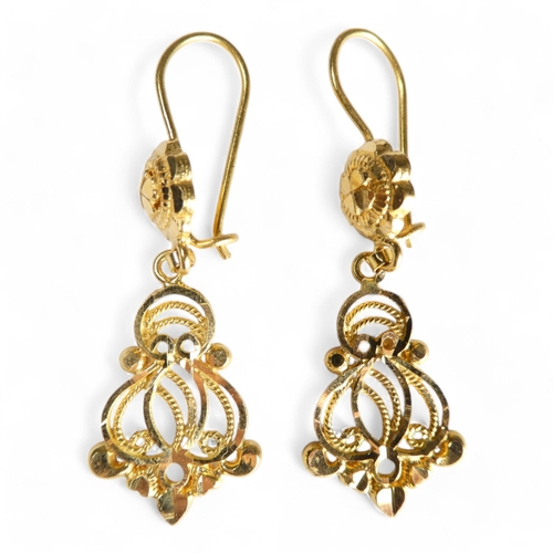 689 - A pair of yellow metal filigree earrings - of foliate form, stamped 21ct, together with another simi... 