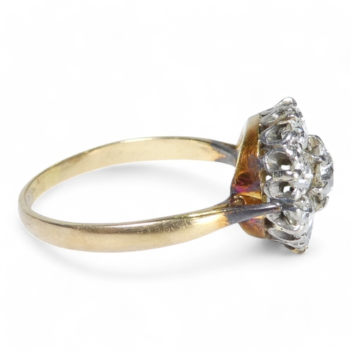 690 - An 18ct diamond cluster ring - with a central claw set stone, approx. 0.75ct, within a band of small... 