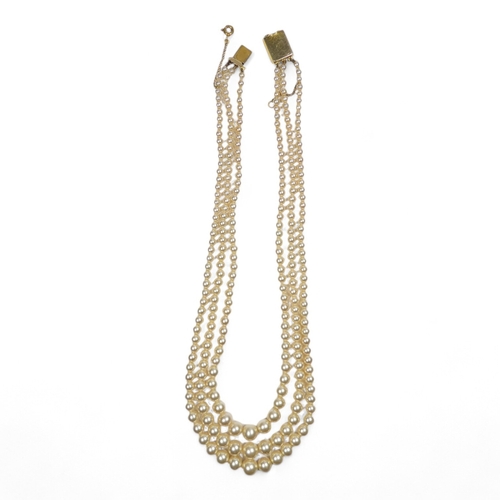 692 - A three string set of graduated pearls - with a 9ct gold clasp, 36cm long.