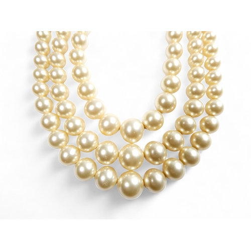 692 - A three string set of graduated pearls - with a 9ct gold clasp, 36cm long.