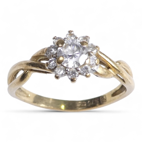 696 - A 9ct gold ring - floral set with cubic zirconia, size K, 1.6g.