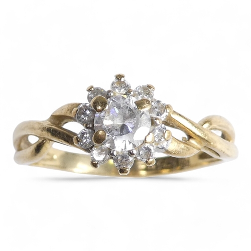 696 - A 9ct gold ring - floral set with cubic zirconia, size K, 1.6g.