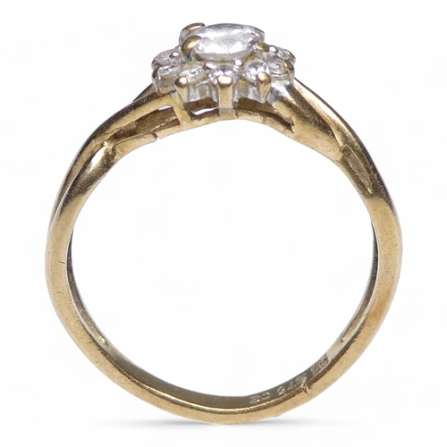 696 - A 9ct gold ring - floral set with cubic zirconia, size K, 1.6g.