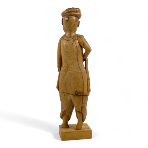 7 - A late 19th century carved oriental hardwood figure - wearing a turban and traditional clothes with ... 