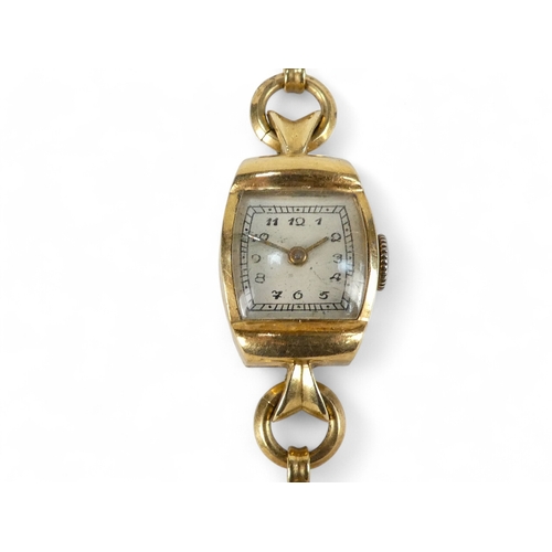 743 - A 9ct gold ladies cocktail watch - the cream dial set out in Arabic numerals, on a 9ct snake link go... 