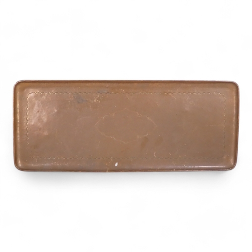 75 - An early 20th century Newlyn copper tray - of rectangular form, with a vacant cartouche and scallope... 