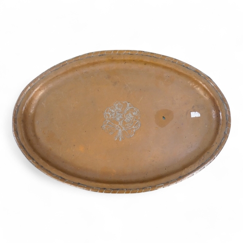 76 - Hugh Wallis (British, 1871-1943) oval copper tray - decorated with a bouquet of flowers, 50 x 33cm, ... 